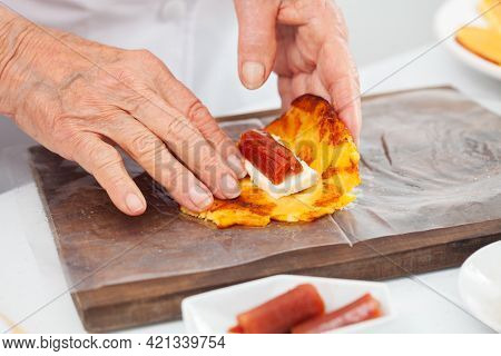 Senior Woman Preparing A Traditional Dish From El Valle Del Cauca In Colombia Called Aborrajado