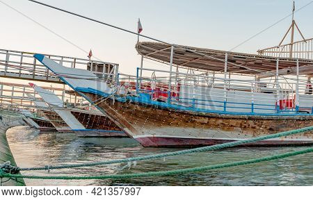 Traditional Dhows Parked Together In Doha Corniche. Selective Focus