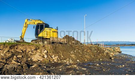 Foxton Beach, Horowhenua, New Zealand, 05.14.2021. Yellow Excavator Doing The Digging Work On Buildi
