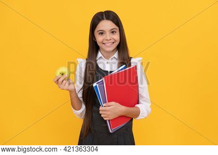 Happy School-aged Girl Child Hold Apple And Books Yellow Background, Knowledge