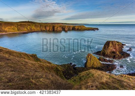 View Of The Coastline With Cliff And Beach At Castle Haven, Dunnottar Castle Area.stonehaven, Aberde