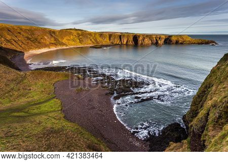 View Of The Coastline With Cliff And Beach At Castle Haven, Dunnottar Castle Area.stonehaven, Aberde