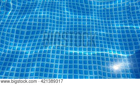 Water Surface Texture With Looping Clean Swimming Pool Ripples And Waves. Refraction Of Sunlight Top