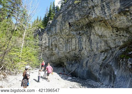 Grotto Canyon, Canmore, Alberta, Canada - May 16th, 2021: Families Hiking The Grotto Canyon Trail Wi