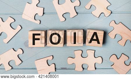 Blank Puzzles And Wooden Cubes With The Text Foia The Freedom Of Information Act Lie On A Light Blue