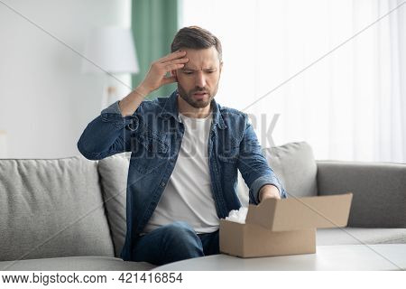 Disappointed Man Customer Checking Mail Box At Home