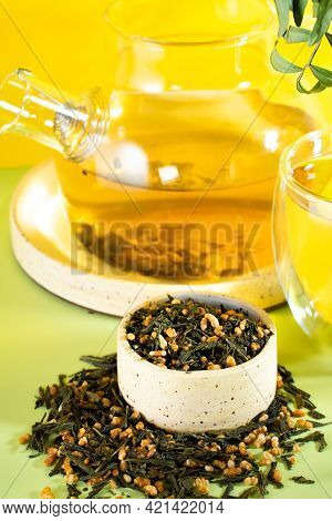Japanese Green Tea Genmaicha.tea Leaves With Fried Brown Rice On A Bright Yellow Background With A S