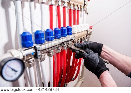Pipefitter Install System Of Underfloor Heating System At Home
