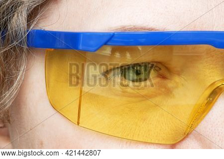 Portrait Of A Woman In Yellow-blue Construction Goggles, A Woman Is A Welder Or An Engineer, Or A Bu
