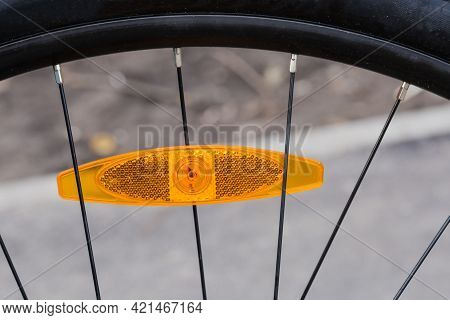 Fragment Of Bicycle Wheel With Plastic Reflector Orange Color Installed Between The Spokes
