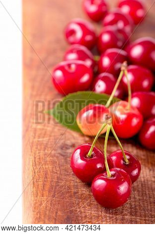 Cherries On Wooden Table With Water Drops Macro Background