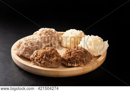 Cocada, Coconut Candy From Brazil, White And Brown Cocadas On Round Wood, Black Background, Selectiv