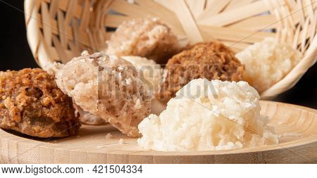 Cocada, Coconut Candy From Brazil, White And Brown Cocadas On Round Wood Fallen From A Straw Basket,