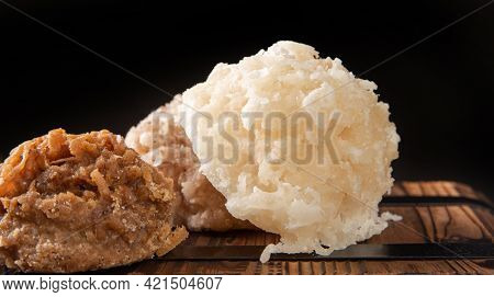 Cocada, Coconut Candy From Brazil, White And Brown Cocadas In Close Up On A Rustic Wooden Surface An