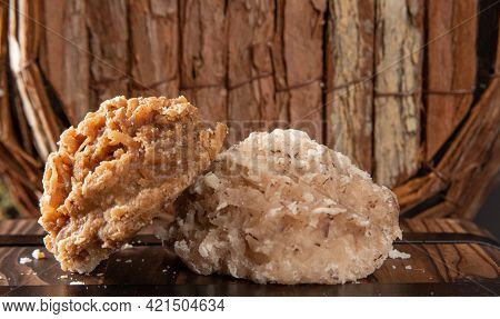 Cocada, Coconut Candy From Brazil, White And Brown Cocadas In Close Up On A Rustic Wooden Surface An