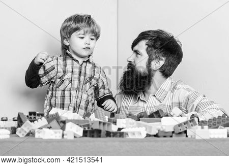 Dad And Kid Build Plastic Blocks. Child Care Development. Family Leisure. Father And Son Create Cons