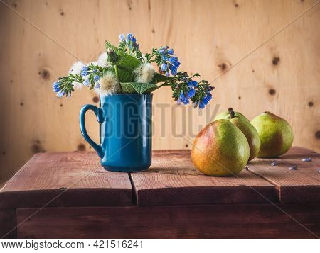 Green Pears And A Bouquet Of Spring Primroses, Fluffy Dandelions And Symphytum Caucasicum On The Kit