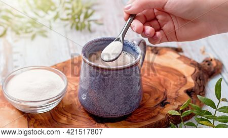 Woman Adding Collagen Powder To Her Morning Coffee. Beauty Collagen Supplement, Additional Collagen 
