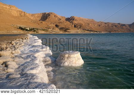 Salt Crystals On The Dead Sea Coast During Sunrise
