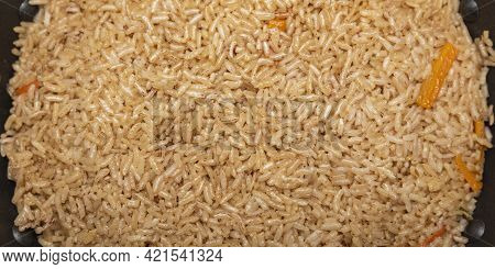 Pilaf Rice Close Up. Oriental Cuisine Concept. National Uzbek Pilaf With Meat In A Cast Iron Pan. To