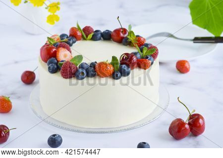 Top View On Homemade Vanilla Birthday Cake Decorated With Berries: Strawberries, Blueberries, Cherri