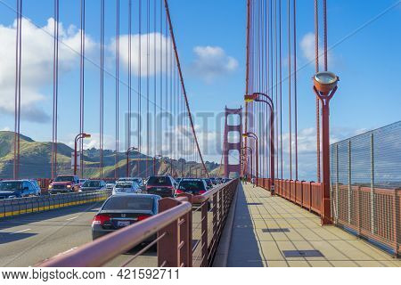 San Francisco,ca,usa - April 28, 2018 : Many Tourists Walking Up The Golden Gate Bridge Against Blue