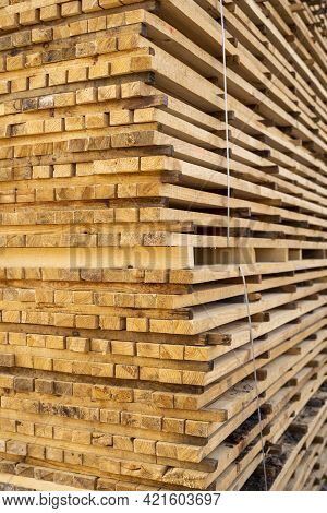 Storage Of Piles Of Wooden Boards On The Sawmill. Boards Are Stacked In A Carpentry Shop. Sawing Dry