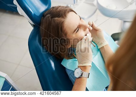 Underage Patient Is Undergoing Teeth Care Procedure