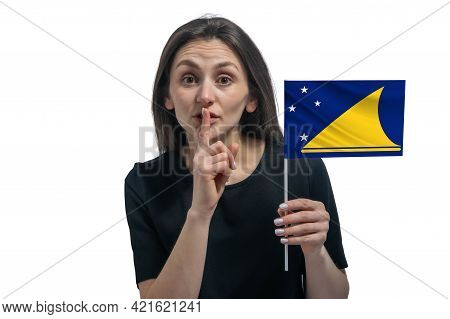Happy Young White Woman Holding Flag Of Tokelau And Holds A Finger To Her Lips Isolated On A White B
