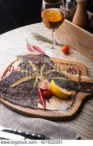 Fried Fish Served On Wooden Board At Bar