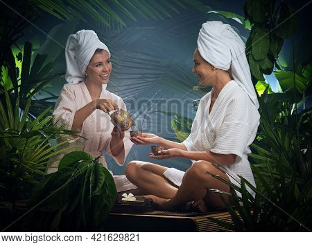 Portrait Of Young Beautiful Women Drinking Tea  In Spa Environment.
