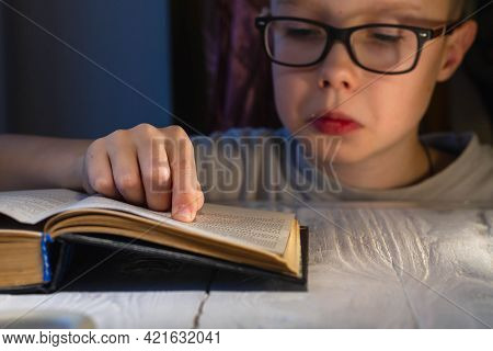 A Teenage Caucasian Boy With Glasses Is Having A Hard Time Reading A Book And Trying To Make Sense O