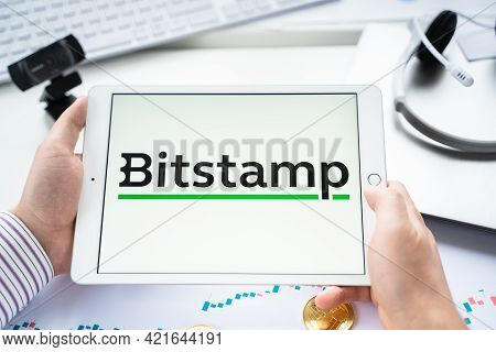 Russia Moscow 05.05.2021.businessman Holding Tablet With Logo Of Cryptocurrency Stock Exchange Bitst