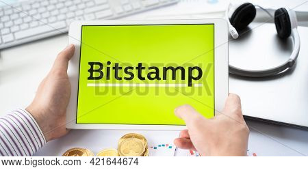 Russia Moscow 05.05.2021.businessman Holding Tablet With Logo Of Cryptocurrency Stock Exchange Bitst