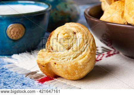Fresh homemade puff pastry rolls with cinnamon. Selective focus.