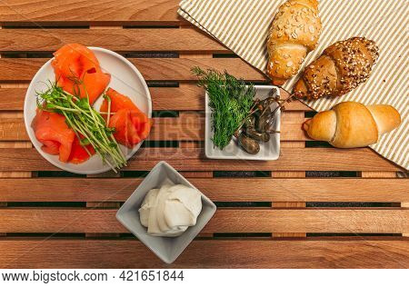 Lox, Croissants, Cream, Capers And Other Ingredients Prepared To Cooking - Top View. Traditional Fre