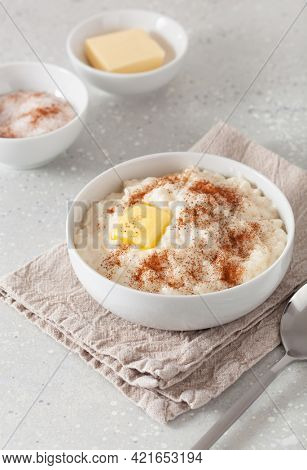 rice pudding with butter cinnamon. french riz au lait, norwegian risgrot, traditional breakfast dessert