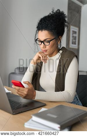 Vertical Shot Of Young Adult Serious African American Mixed Race Girl Using Smart Cell Phone Mobile 