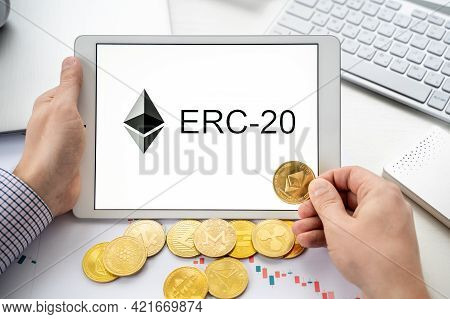 Russia Moscow 06.05.2021.businessman Holding Tablet With Logo Of Erc-20 Official Protocol Of Ethereu