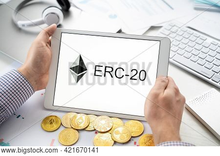 Russia Moscow 06.05.2021.businessman Holding Tablet With Logo Of Erc-20 Official Protocol Of Ethereu
