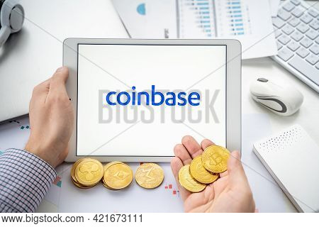Russia Moscow 06.05.2021.businessman With Tablet.logo Of Cryptocurrency Stock Exchange Coinbase.trad