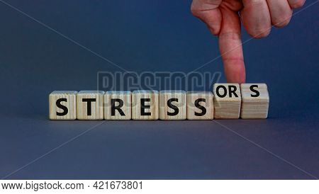 Stress And Stressors Symbol. Businessman Turns Cubes, Changes Words 'stress' To 'stressors'. Beautif