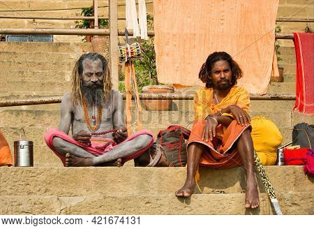 Varanasi, India - November 01, 2016: Two Hindu Bearded Sadhu, Pilgrim With Damru On Spear Sitting In