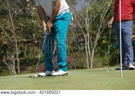 Golfers Are Putting Golf In The Evening Golf Course Golf Backglound. Golfer Hitting Golf Ball. Sport