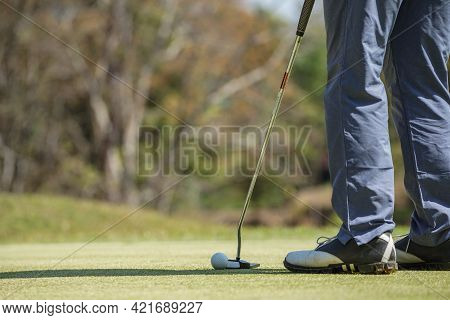 Golfers Are Putting Golf In The Evening Golf Course Golf Backglound. Golfer Hitting Golf Ball. Sport