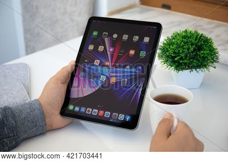 Alanya, Turkey - May 11, 2021: Man Hand Holding Ipad Air Ios 14 With Widget On The Home Screen. Ipad