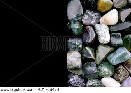 Moss Agate Heap Jewel Stones Texture On Half Black Background. Place For Text.