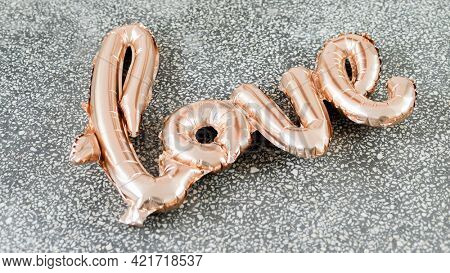 Love glossy orange balloon on a floor
