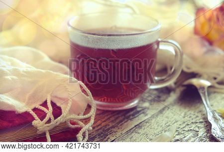 Cup Of  Tea, Neutral Scarf On Wooden Table, Sun Glare And Bokeh, The Concept Of Home Comfort, Retro 