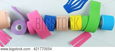 Rolls Kinesiology Tape For Athletes On Blue. Body Correction And Acceleration Of Lymph Outflow.